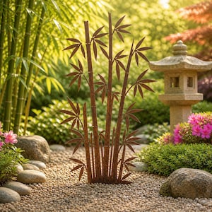 May include: A rusty brown metal bamboo sculpture stands in a garden setting. The sculpture features multiple bamboo stalks with detailed leaf cutouts. The background includes lush greenery, rocks, and a stone lantern, creating a serene outdoor scene.