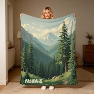Custom Name Serene Mountain Forest Blanket, Personalized Flannel Throw with Pine Trees & Scenic Valley for Nature Lovers.