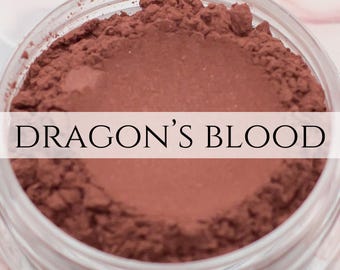 May include: A close-up of a jar of red-brown powder labeled "DRAGON'S BLOOD".
