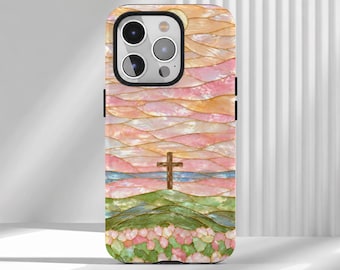 May include: A smartphone case featuring a stained-glass style design of a brown cross standing on a green hill. The background displays layered waves of pink, peach, and blue hues, creating a textured, iridescent appearance across the surface.