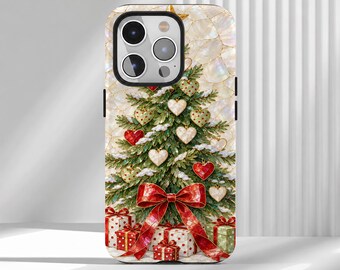May include: A smartphone case featuring a Christmas tree decorated with heart-shaped ornaments, dusted with snow, and topped with a star. A large red ribbon bow sits at the base, surrounded by several wrapped gift boxes on a pearlescent background.