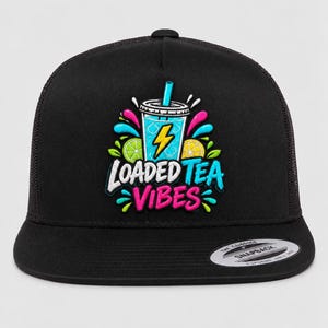 May include: A black snapback cap featuring a colourful embroidered graphic of a blue drink in a cup with a straw, lime and lemon slices, and the text "LOADED TEA VIBES" in white and pink lettering. The hat has a flat brim and mesh back panels.