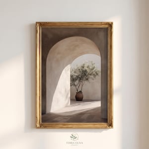 May include: A framed art print featuring an olive tree in a terracotta pot, set within an arched architectural space. The artwork has a warm color palette with gold accents, and the print is labeled "TERRA OLIVA PRINTS".