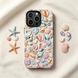 May include: A smartphone case featuring a repeating pattern of various seashells and starfish in soft pastel colors including pink, blue, and cream. The case has a black camera cutout area. Two starfish and several loose seashells are placed nearby.