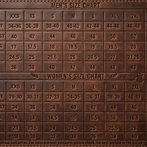 May include: A brown leather-textured chart displaying sizing information in inches. The grid includes rows for body chest, jacket chest, shoulders, sleeves, and waist measurements for various sizes ranging from XXS to 4XL for two distinct categories.