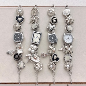 May include: Four silver charm bracelets with various embellishments, including small watches, hearts, bows, and floral designs. Each bracelet has a different combination of charms and a delicate chain.