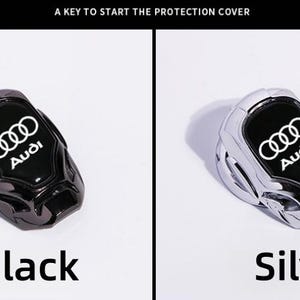 May include: Black and silver car key fob covers with the Audi logo. The covers are shown side-by-side, with the word "Black" below the black cover and "Silver" below the silver cover. The text "A KEY TO START THE PROTECTION COVER" is at the top.