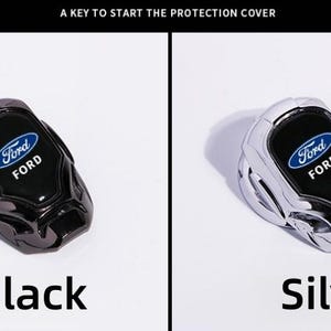 May include: Black and silver Ford car ignition button covers. The covers have the Ford logo in blue and white. The text "A KEY TO START THE PROTECTION COVER" is at the top of the image. The word "Black" and "Silver" are at the bottom of the image.
