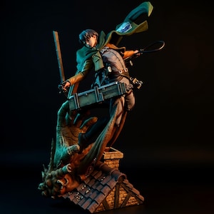 May include: A detailed figurine of a character from the anime series Attack on Titan. The figure is posed dynamically, holding a sword and a whip, with a green cape and a box on the back. The figure is standing on a rooftop with a monster hand.