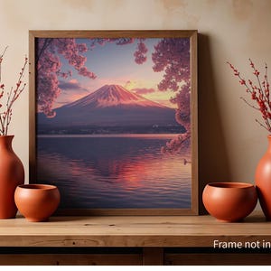 May include: A framed print of Mount Fuji at sunset, with cherry blossoms. Two orange vases and a bowl are on a wooden surface, with red branches. The text "Frame not included" is at the bottom of the image.