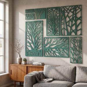 May include: A set of seven dark green wall art panels featuring intricate laser-cut tree branch and forest patterns. The largest panel includes the text "TO LOVE" integrated into the design. The panels are arranged in a gallery wall layout.