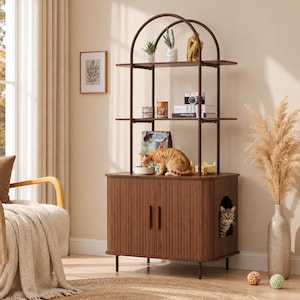 May include: A brown cat furniture piece with a built-in cat house and shelves. The unit has a dark brown finish and a vertical slatted design on the cabinet doors. A cat is eating from a bowl on top, and another cat is inside the cat house.