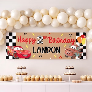May include: A rectangular birthday banner featuring a tan background with a black and white checkered border. The text reads Happy 2nd Birthday Landon in red and black. It includes illustrations of a red race car and a brown tow truck.