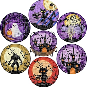 May include: A set of six circular Halloween-themed diamond art coasters featuring designs of a ghost, a cat, a skeleton hand, a werewolf, a devil, and a haunted castle, all stored in a black metal wire holder with a purple, orange, and yellow palette.