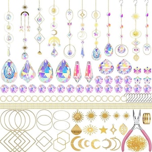 Può includere: Una collezione di acchiappasole in cristallo e materiali per il fai-da-te. Gli acchiappasole presentano cristalli iridescenti, dettagli in metallo color oro e varie forme come lune, stelle e disegni geometrici. Sono inclusi componenti aggiuntivi.