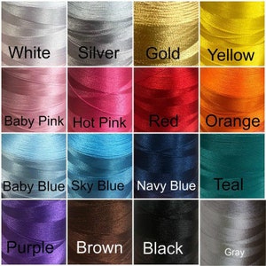 May include: A color chart of spools of thread in various colors, including white, silver, gold, yellow, baby pink, hot pink, red, orange, baby blue, sky blue, navy blue, teal, purple, brown, black, and gray. Each spool is labeled with its color name.