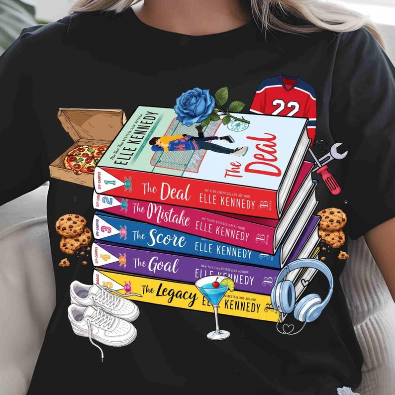 May include: Black t-shirt with a design featuring a stack of books by Elle Kennedy, including "The Deal" and "The Mistake". The design also includes a pizza box, cookies, trainers, a cocktail, and a hockey jersey.