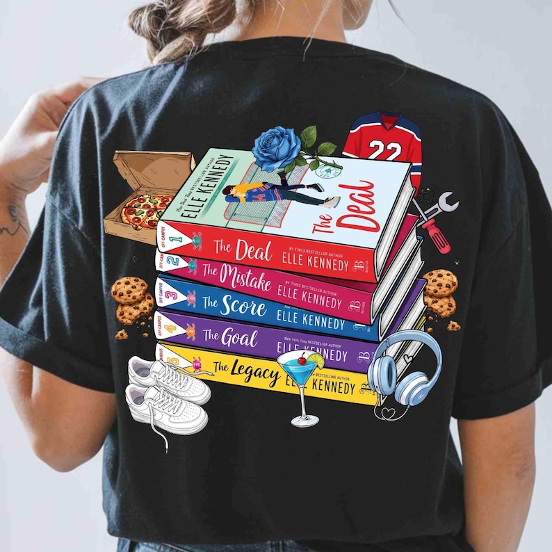May include: Black t-shirt with a design featuring a stack of books by Elle Kennedy, including "The Deal" and "The Mistake". The design also includes a pizza box, cookies, a hockey jersey, and headphones.