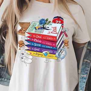 May include: White t-shirt with a design featuring a stack of books with titles including "The Deal" and "The Mistake" by Elle Kennedy. The design also includes a hockey jersey, pizza, and sneakers.