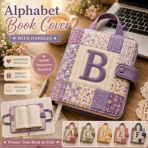 May include: A quilted fabric book cover featuring a large purple letter B on the front, constructed from various purple and cream floral patterned patches. The cover includes a top handle, a snap-button closure strap, and a white ribbon bookmark.