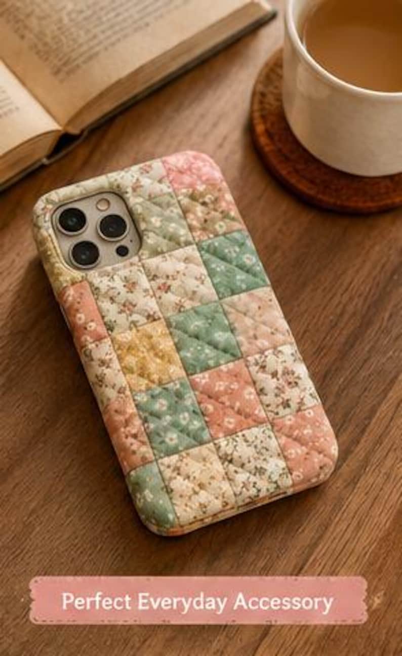 May include: A rectangular phone case featuring a quilted patchwork design with a grid of squares in soft shades of pink, green, yellow, and cream, each decorated with a small floral pattern. The case has a cutout for a triple camera lens system.