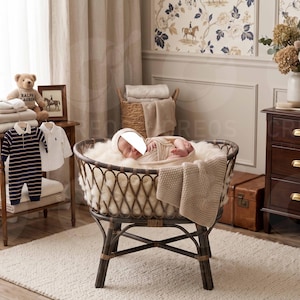 May include: A round, dark brown wicker bassinet with a woven lattice design, featuring a plush white faux fur lining and a draped beige knit blanket. The bassinet stands on a sturdy, four-legged base with cross-bracing, providing a stable structure.
