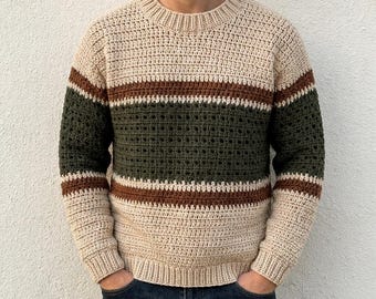 May include: A long-sleeve crochet sweater featuring a crew neckline and a color-blocked striped pattern. The design consists of wide bands of cream, followed by thinner brown stripes, and a central wide band of dark olive green textured crochet.