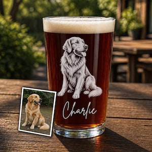 May include: A pint glass filled with dark beer and foam, featuring a detailed illustration of a Golden Retriever dog. The dog's name, "Charlie," is written in cursive below the image. A smaller photo of the dog is in the lower left.