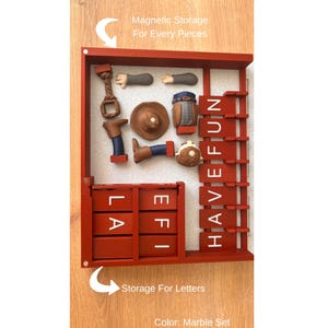 May include: A red wooden storage box with compartments for letters and magnetic storage for pieces. The box contains miniature cowboy-themed figurines and the words "HAVE FUN" and "LA EFI" in white letters. The text "Magnetic Storage For Every Pieces" is also visible.