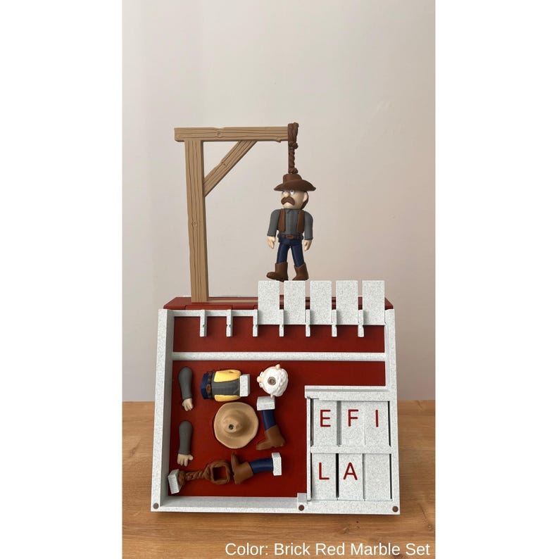 May include: A brick red marble set featuring a miniature cowboy figure standing under a gallows. The set includes a red and white structure with a fence, and various cowboy-themed accessories. The text "EFI LA" is visible.