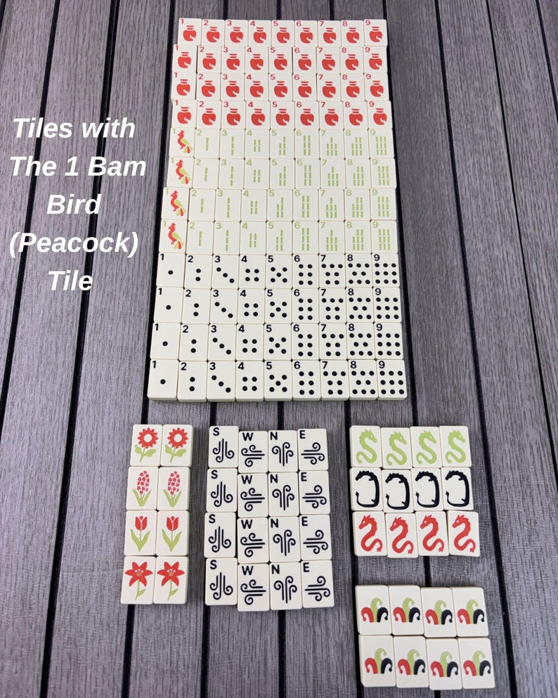May include: A complete set of off-white Mahjong tiles arranged in rows. The tiles feature red character symbols, green bamboo sticks, black dots, flower illustrations, directional letters S, W, N, E, dragons, and the 1 Bam Bird Peacock tile.