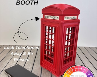 May include: A bright red telephone booth model with a grid-patterned frame and the word TELEPHONES printed on the top panels. Next to it lies a black smartphone. Text on the image reads TELEPHONES BOOTH, Lock Telephones Away & Be Present.