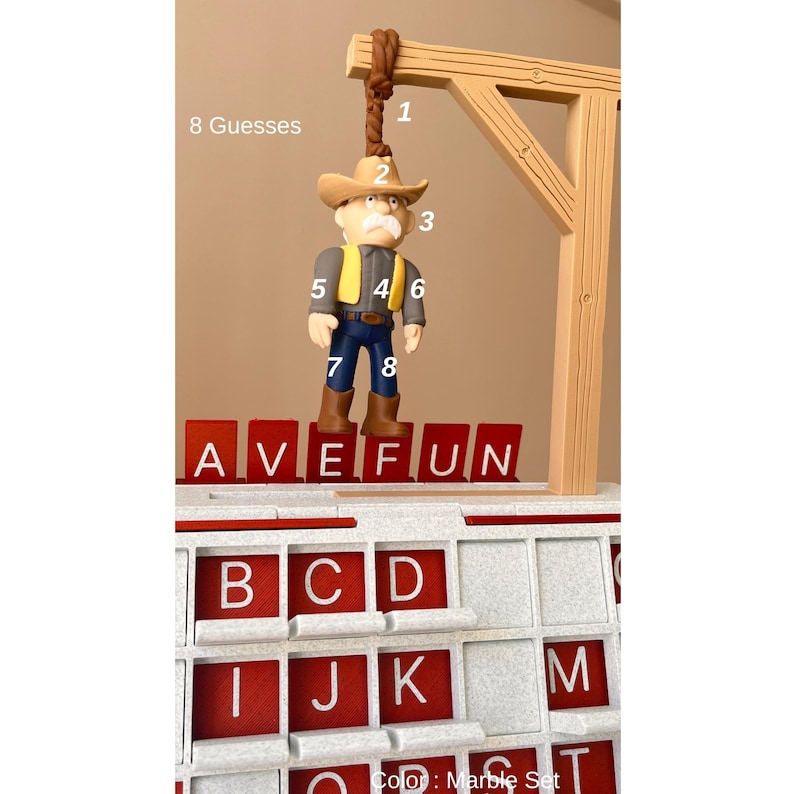 May include: A word game set with a cowboy figure suspended from a wooden gallows. The game includes red letter tiles spelling "AVE FUN" and a board with letter slots. The text "8 Guesses" is visible.