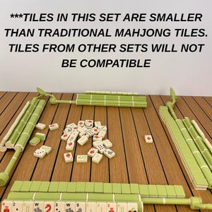 May include: A Mahjong set featuring light green tile racks shaped like bamboo stalks and a collection of small white tiles with red, black, and green markings. Text reads: ***TILES IN THIS SET ARE SMALLER THAN TRADITIONAL MAHJONG TILES. TILES FROM OTHER SETS WILL NOT BE COMPATIBLE
