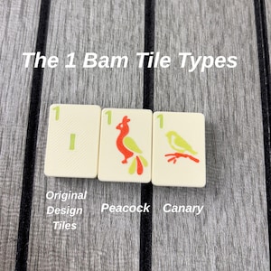 May include: Three off-white Mahjong tiles labeled The 1 Bam Tile Types. The first tile shows a green number 1 and a vertical bar. The second tile features a red and green peacock. The third tile displays a yellow and red canary on a branch.