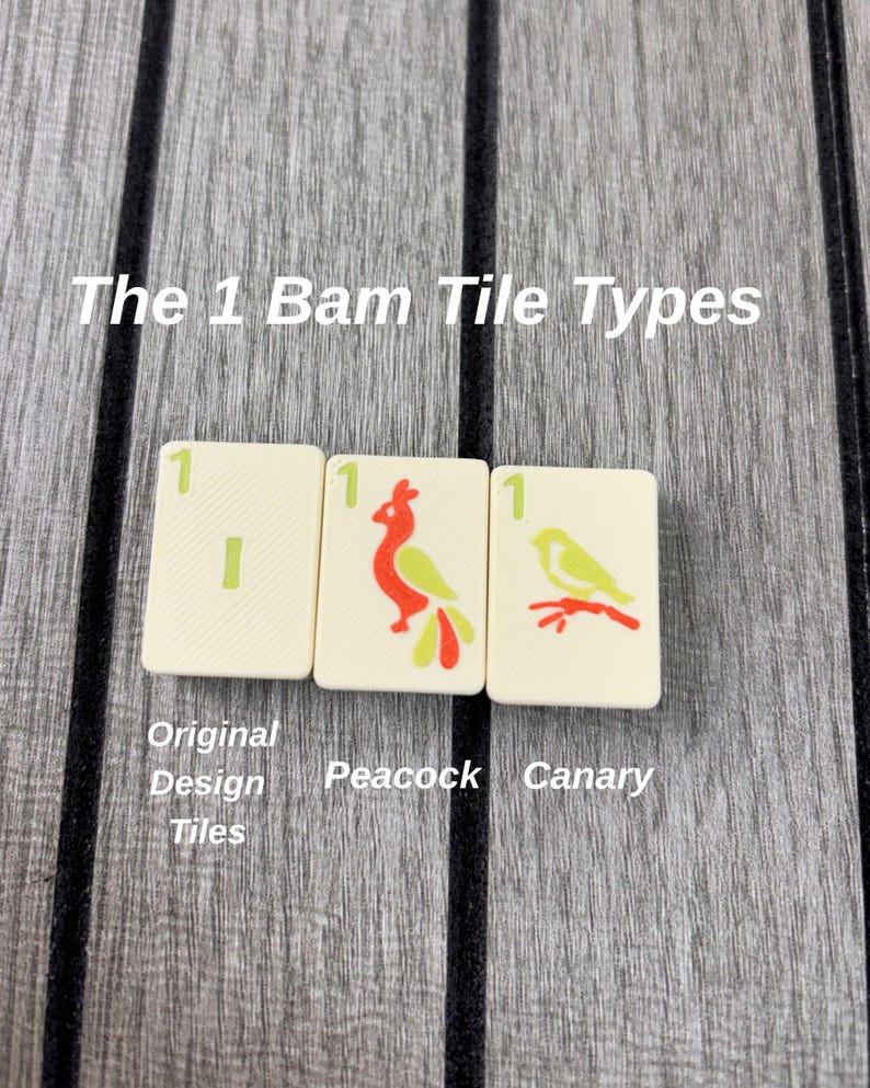 May include: Three off-white Mahjong tiles labeled The 1 Bam Tile Types. The first tile shows a green number 1 and a vertical bar. The second tile features a red and green peacock. The third tile displays a yellow and red canary on a branch.