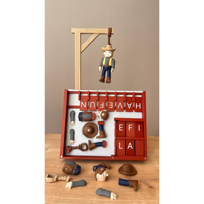 May include: A handcrafted cowboy-themed display. It features a miniature cowboy figure hanging from a wooden gallows, with the words "HAVE FUN" spelled out on a red frame. Additional cowboy-related accessories are included.