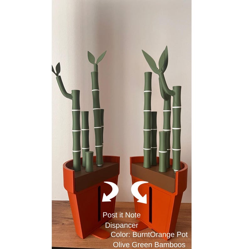 May include: A burnt orange pot-shaped Post-it Note dispenser with olive green bamboo stalks and leaves. The bamboo stalks have white bands. The text "Post it Note Dispancer" and "Color: BurntOrange Pot Olive Green Bamboos" is visible.