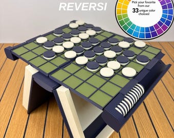 May include: A Playbook'd Reversi board game with a green grid surface, dark blue frame, and white and dark blue circular game pieces. A circular graphic in the corner displays a colour wheel with text stating: Pick your favourite from our 33 unique colour choices!