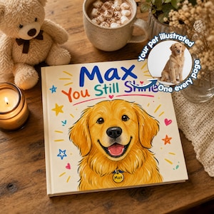 Puede incluir: Un libro infantil titulado "Max You Still Shine" con una ilustración de golden retriever. El libro tiene texto colorido y detalles de estrellas y corazones. Una pequeña ilustración del perro está en la portada. Un oso de peluche, una vela y una taza de chocolate caliente están en el fondo.
