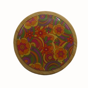 May include: A round wooden coaster with a colourful psychedelic design featuring swirls and flowers in shades of orange, yellow, pink, purple, and green.