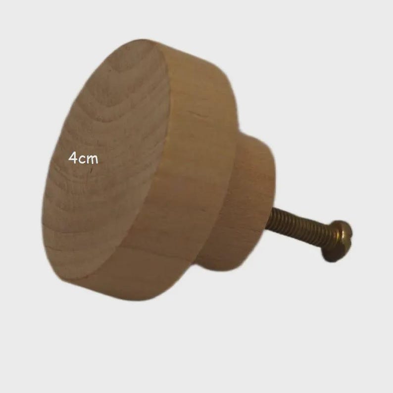 May include: A round, light-coloured wooden cabinet knob with a visible natural grain pattern. The knob features a cylindrical base and a metal screw extending from the back. The text 4cm is printed on the front surface, indicating its diameter.