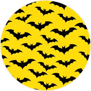 May include: A round, yellow Halloween-themed design featuring a repeating pattern of black bat silhouettes. The bats are evenly spaced across the yellow background, creating a festive and spooky visual.