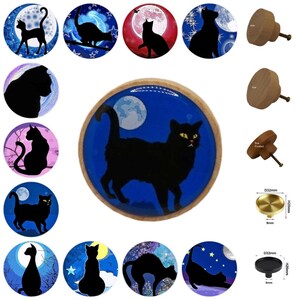 May include: A collection of decorative cabinet knobs and drawer pulls featuring black cat silhouettes against celestial backgrounds. The knobs are round with wooden or metal finishes, and some have a moon and stars design.