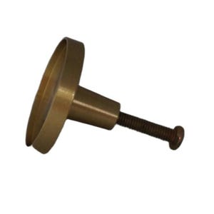 May include: A circular brass-toned cabinet knob featuring a flat, round face with a raised edge and a tapered cylindrical base. A long, threaded metal screw extends from the centre of the base, designed for attachment to furniture or cabinetry.