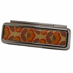May include: A rectangular, silver-toned pill box with a hinged lid. The box features a floral pattern in orange, brown, and yellow. The design is a repeating pattern of stylized flowers.