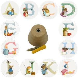 May include: A collection of decorative alphabet letters, each featuring a different animal character. The letters are in various pastel colors. A wooden peg with a screw and wall anchor is also included. The theme is reminiscent of children's stories.