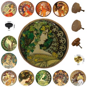 May include: A collection of decorative cabinet knobs and drawer pulls. The knobs feature Art Nouveau style illustrations of women with flowing hair and floral designs. Some knobs are wooden, others are metal.