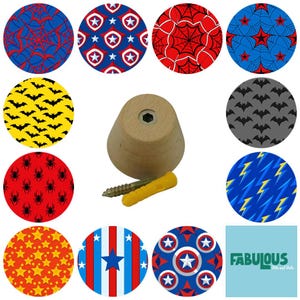 May include: A wooden knob with a screw and wall anchor, surrounded by colorful circular designs. The designs feature spiderwebs, stars, bats, and superhero emblems in red, blue, yellow, and white.