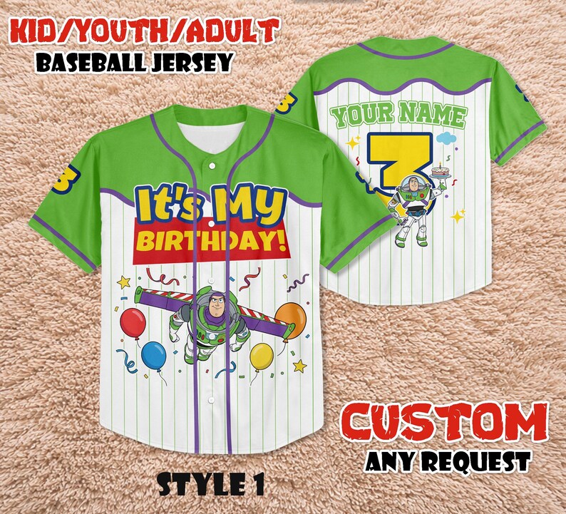 May include: Green and white baseball jersey with "It's My Birthday!" text and a Buzz Lightyear graphic. The jersey has a number 3 on the sleeve and the option to add a name. The jersey is available in youth and adult sizes.